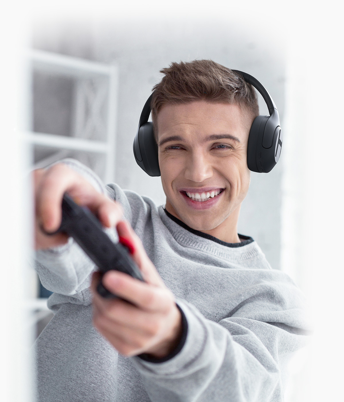 Man gaming and listening to Haylou S35 ANC headphones