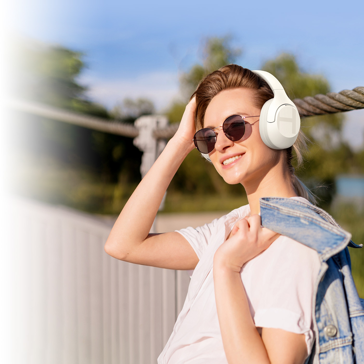 Woman walking and listening to music with Haylou S35 ANC headphones