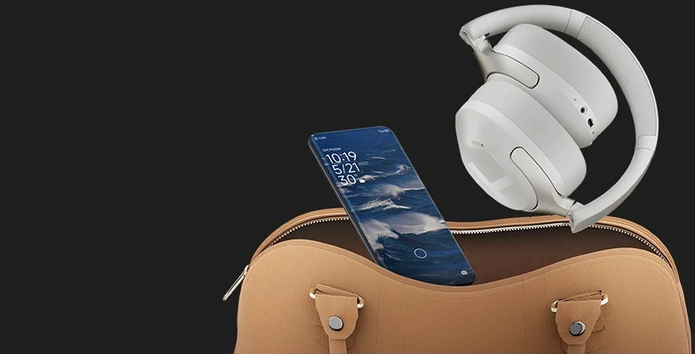 Folded Haylou S40 headphones next to smartphone and travel bag