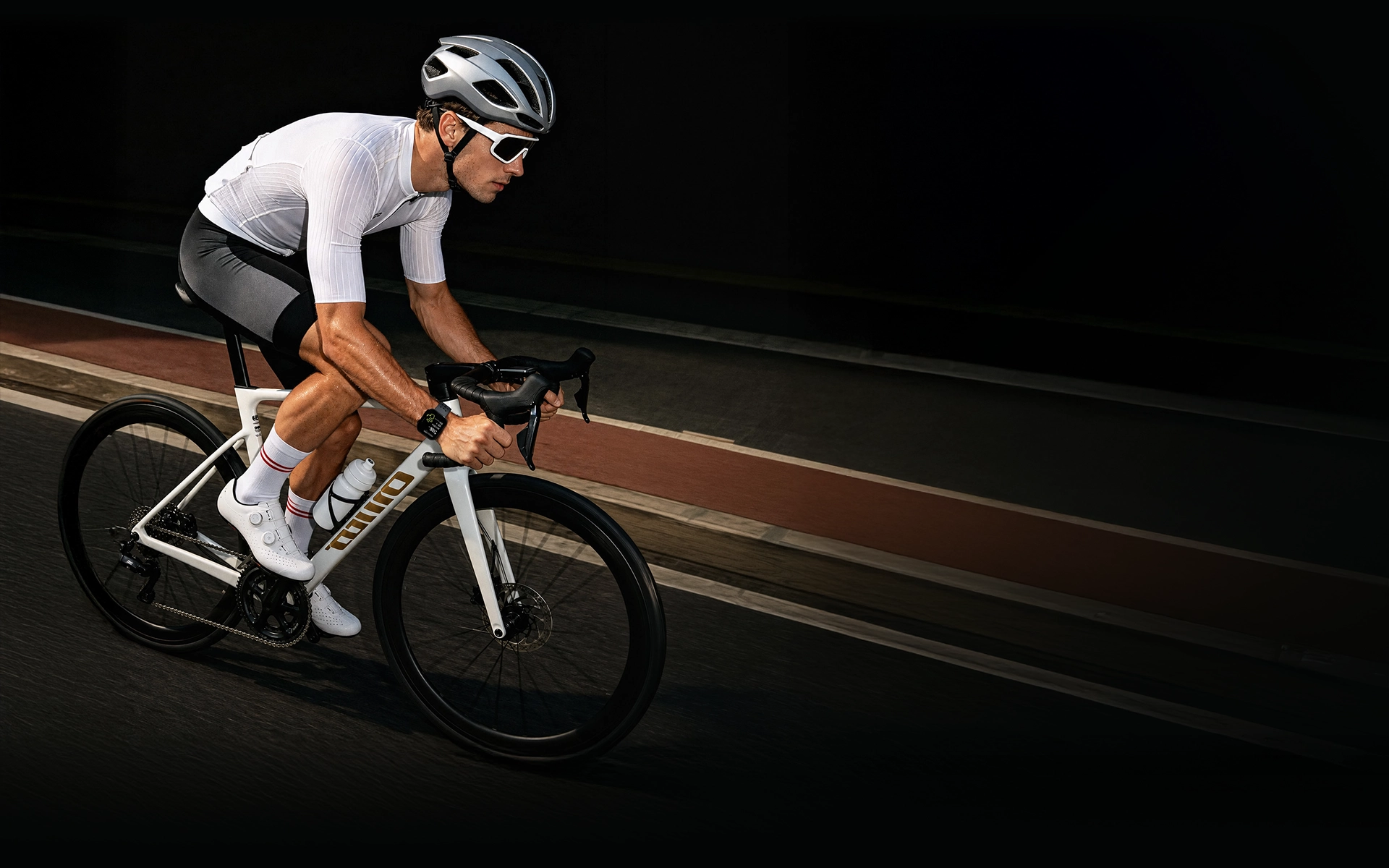 Cyclist wearing smartwatch during road training